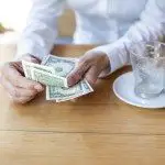 dollar banknotes in hand